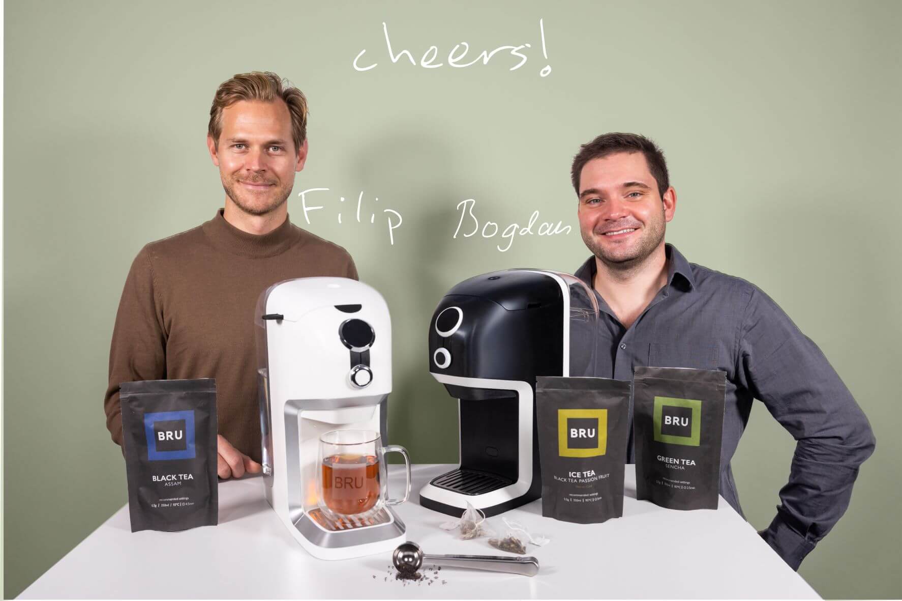BRU automatic tea maker founders Filip and Bogdan standing behind a table with tea machines and teas